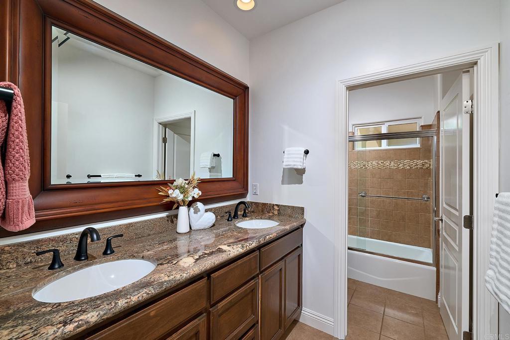 2869 Dos Lomas Place Fallbrook, CA 92028 - Photo 36 of 55 a bathroom with a granite countertop sink and a mirror