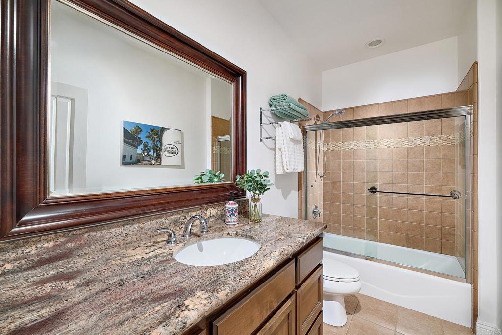 2869 Dos Lomas Place Fallbrook, CA 92028 - Photo 37 of 55 a bathroom with a granite countertop sink and a mirror