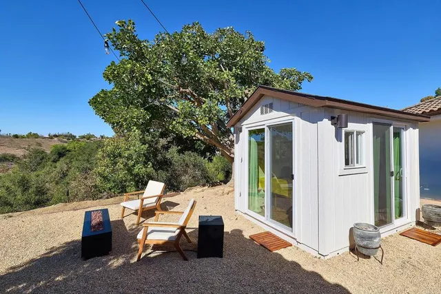 a view of a house with pool porch and sitting area