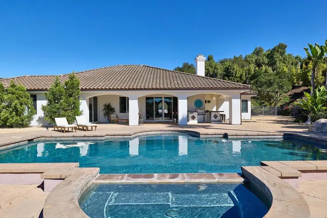a balcony with furniture and a potted plant