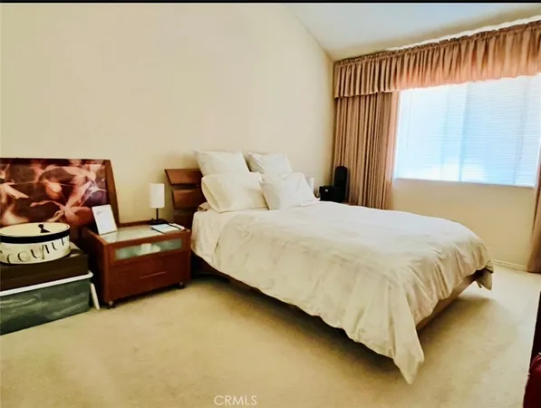 a bedroom with a bed chair and a window