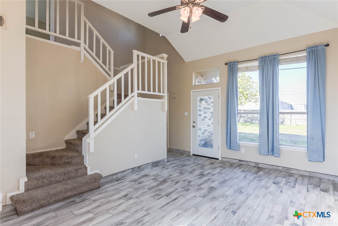 2305 Fieldstone Drive Killeen, TX 76549 - Photo 4 of 18 an empty room with staircase and windows