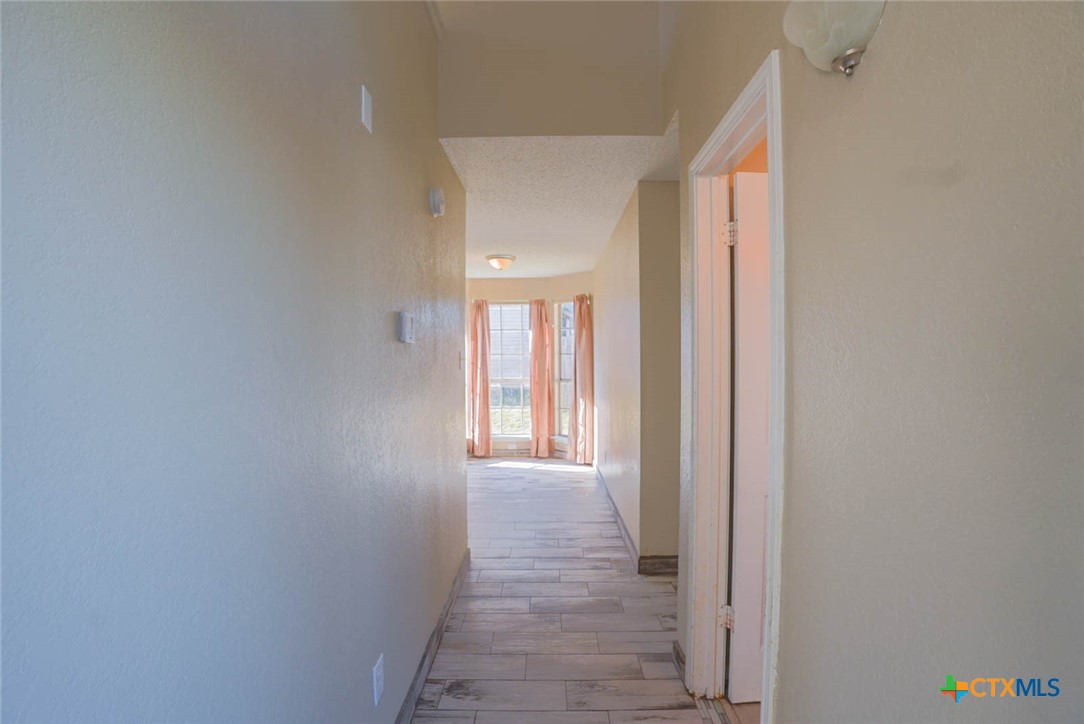 2305 Fieldstone Drive Killeen, TX 76549 - Photo 6 of 18 a view of a hallway with wooden shelves