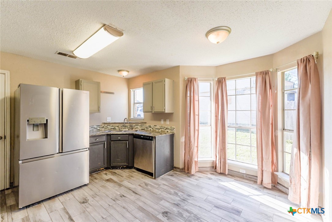 2305 Fieldstone Drive Killeen, TX 76549 - Photo 7 of 18 a kitchen with stainless steel appliances granite countertop a refrigerator and a stove top oven