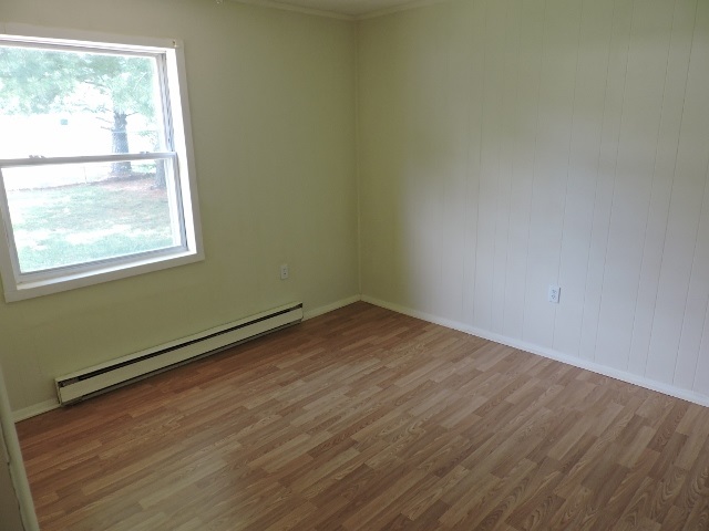 828 Augusta Farms Road Waynesboro, VA 22980 - Photo 9 of 14 an empty room with wooden floor and windows