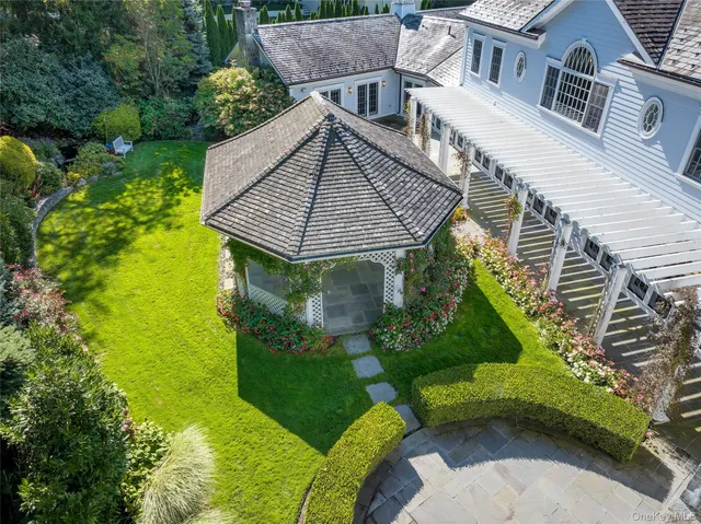 a aerial view of a house with a yard and potted plants