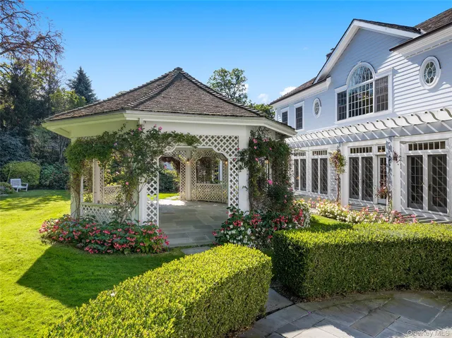 a front view of a house with plants and garden