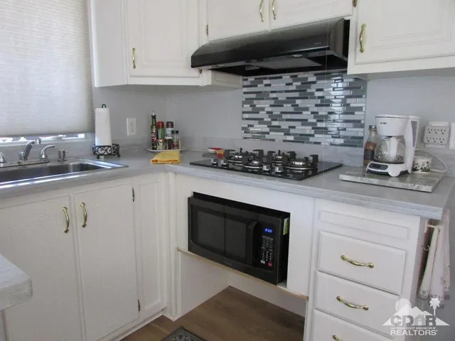 a kitchen with a stove and a sink