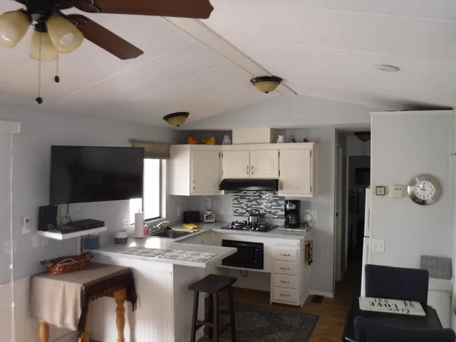 a kitchen with a stove cabinets and a refrigerator