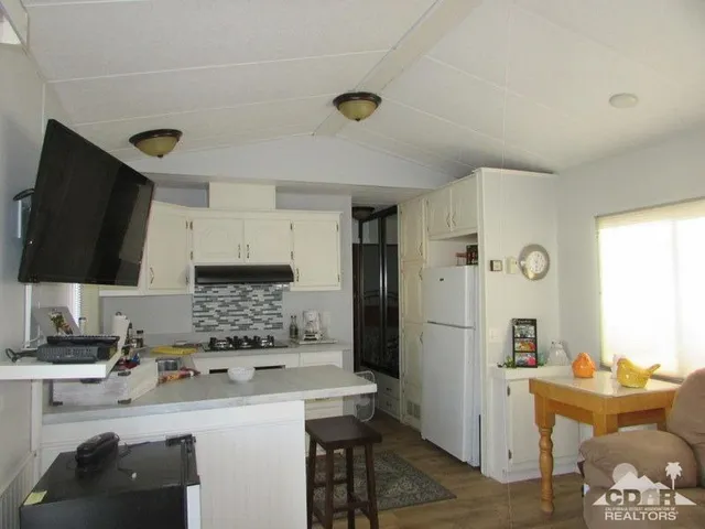 a kitchen with a sink appliances and cabinets