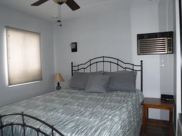 a bedroom with a bed and window