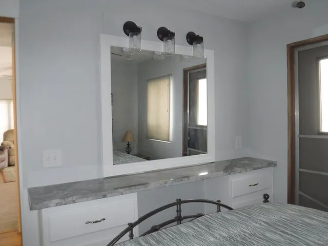 a bathroom with mirror and