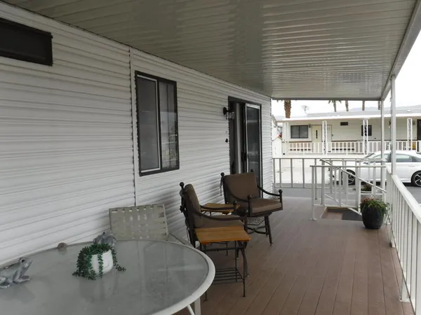 a view of balcony with chairs and wooden floor