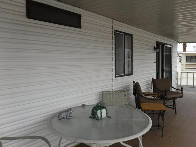 a view of a table and chairs in patio with a yard