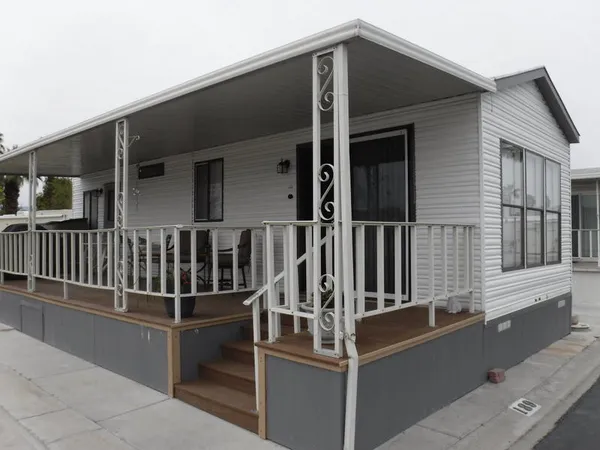a view of a lake with a yard and large trees