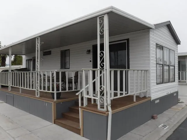 a view of a lake with a yard and large trees