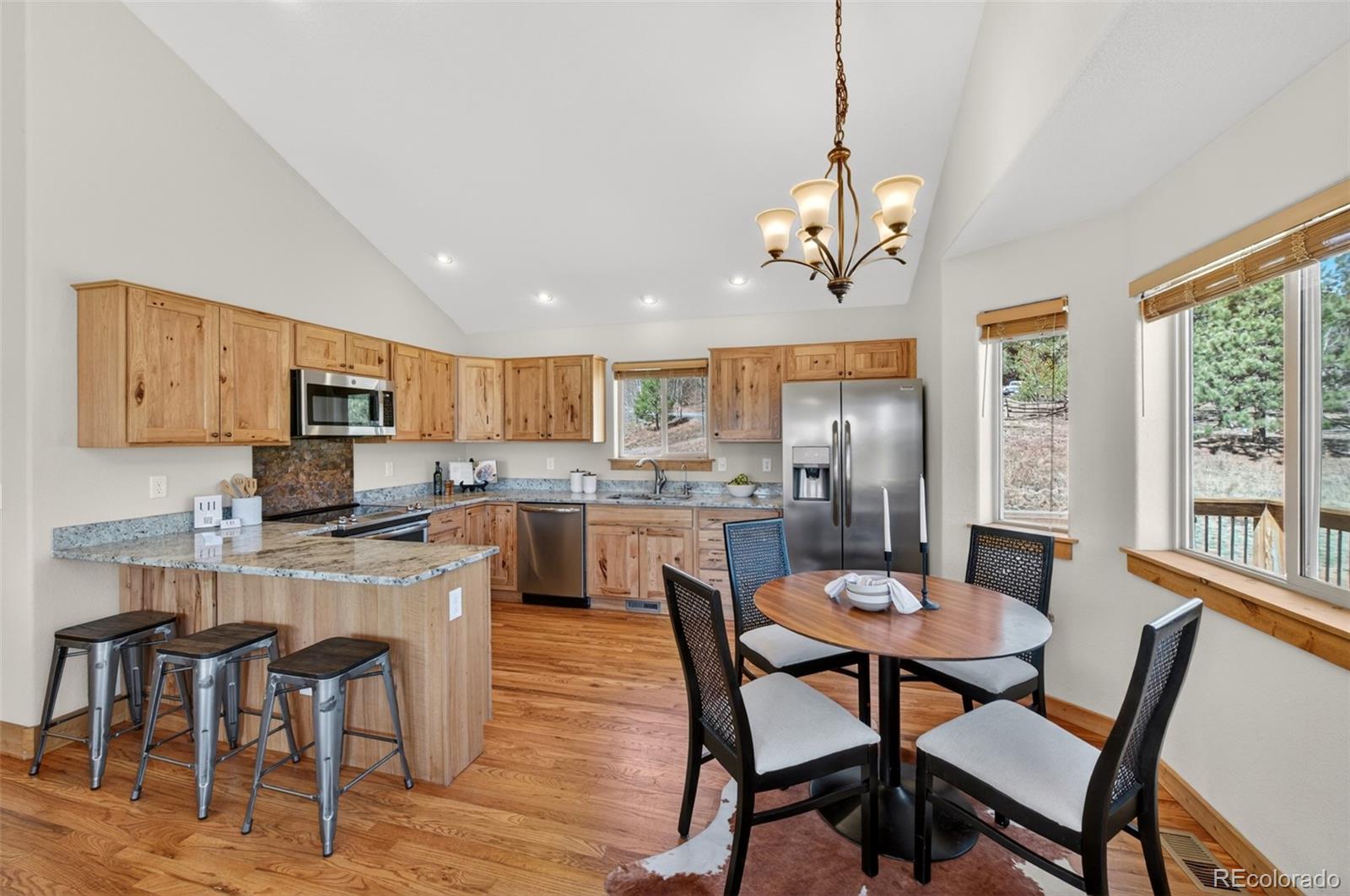 1328 Clark Road Bailey, CO 80421 - Photo 14 of 48 a view of a dining room with furniture window and wooden floor