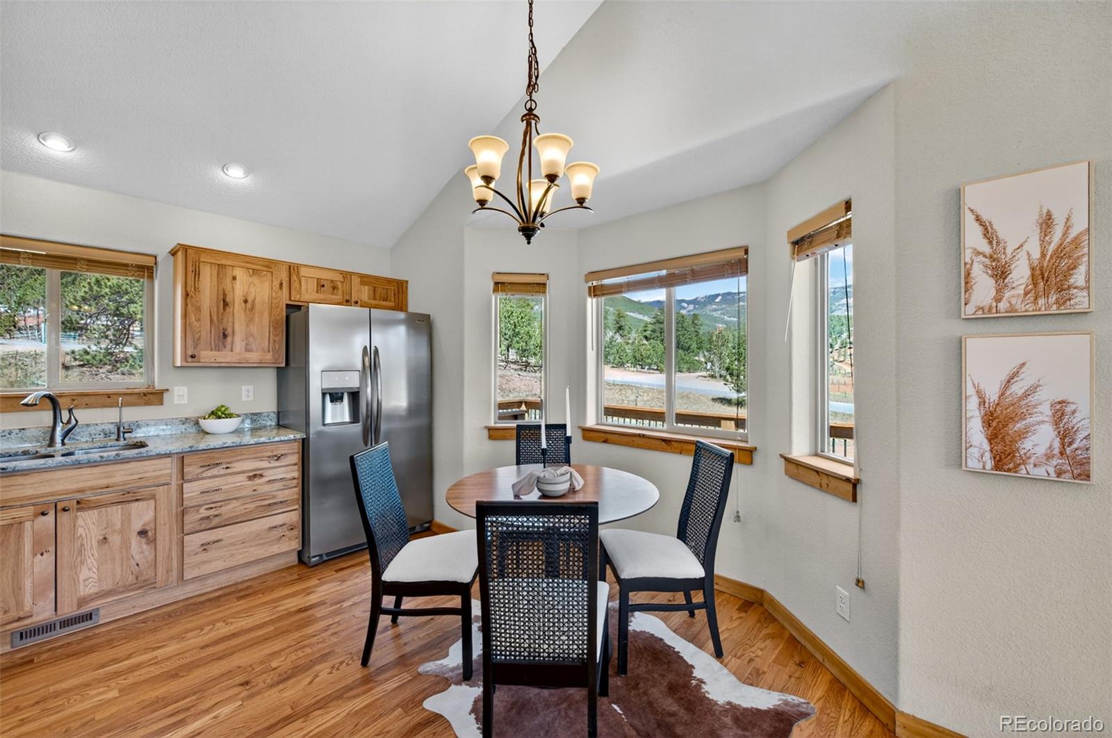 1328 Clark Road Bailey, CO 80421 - Photo 18 of 48 a view of a dining room with furniture a livingroom and wooden floor