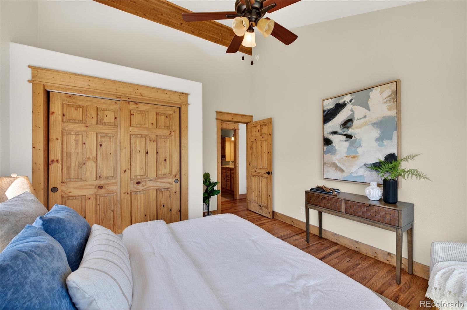 1328 Clark Road Bailey, CO 80421 - Photo 21 of 48 a bedroom with a bed and a chandelier
