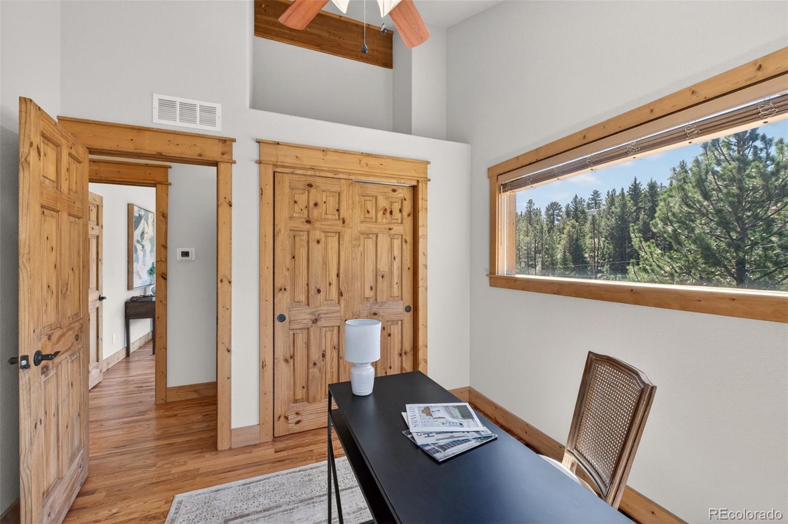 1328 Clark Road Bailey, CO 80421 - Photo 23 of 48 a view of a hallway with wooden floor and windows