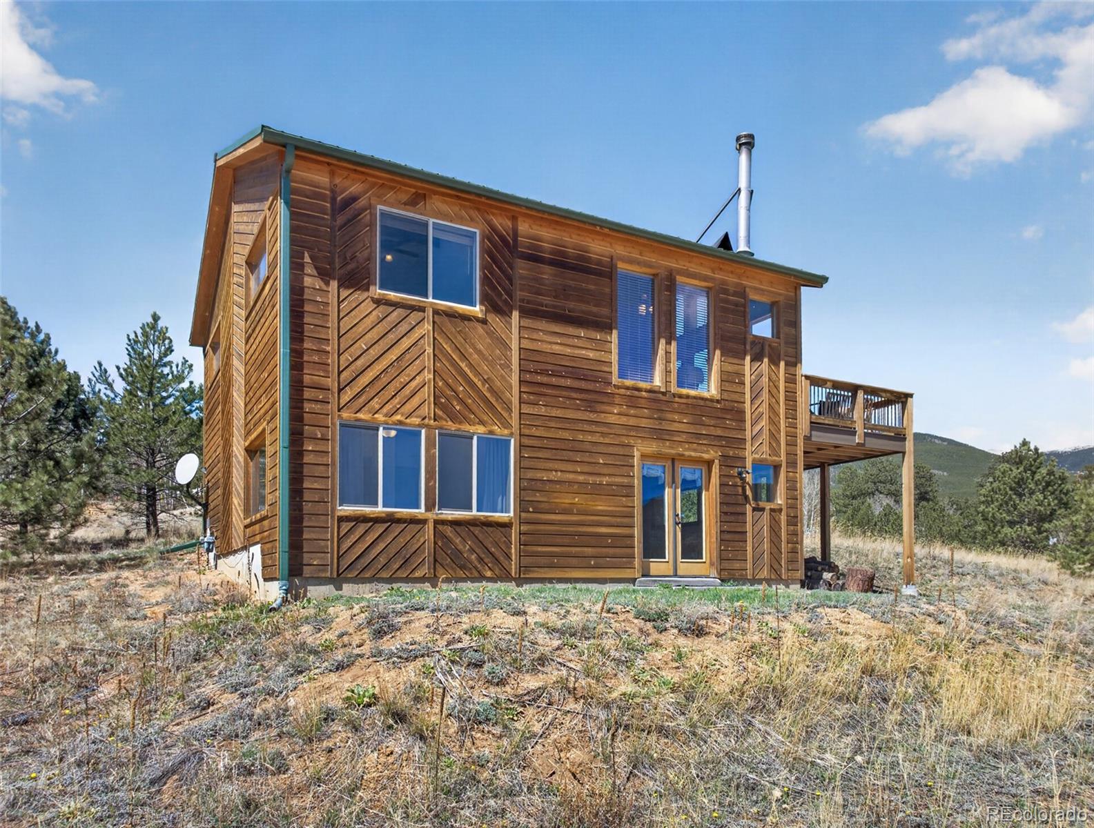 1328 Clark Road Bailey, CO 80421 - Photo 31 of 48 a front view of a house with a yard