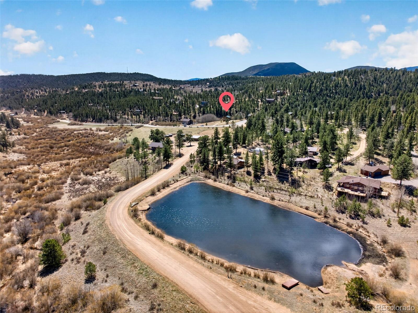 1328 Clark Road Bailey, CO 80421 - Photo 41 of 48 a view of a swimming pool with a yard and mountain view
