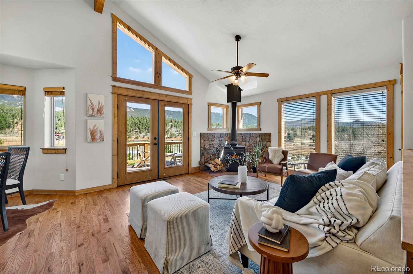 1328 Clark Road Bailey, CO 80421 - Photo 9 of 48 a living room with furniture and a chandelier