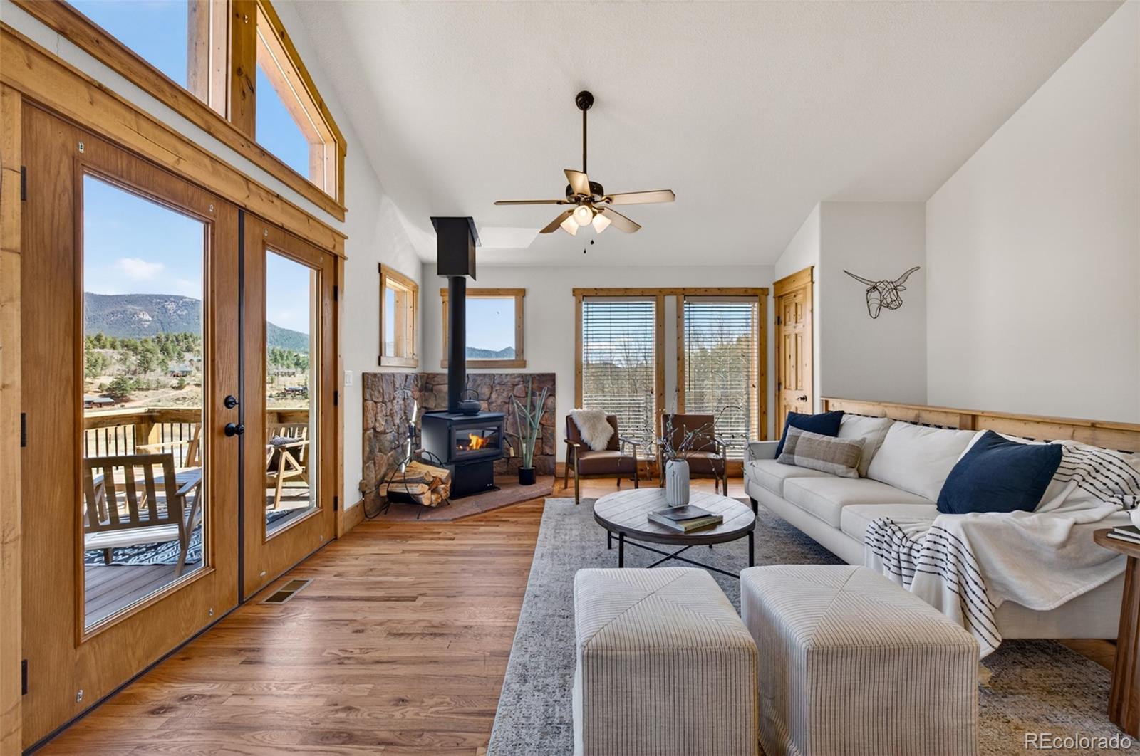 1328 Clark Road Bailey, CO 80421 - Photo 10 of 48 a living room with furniture large window and wooden floor