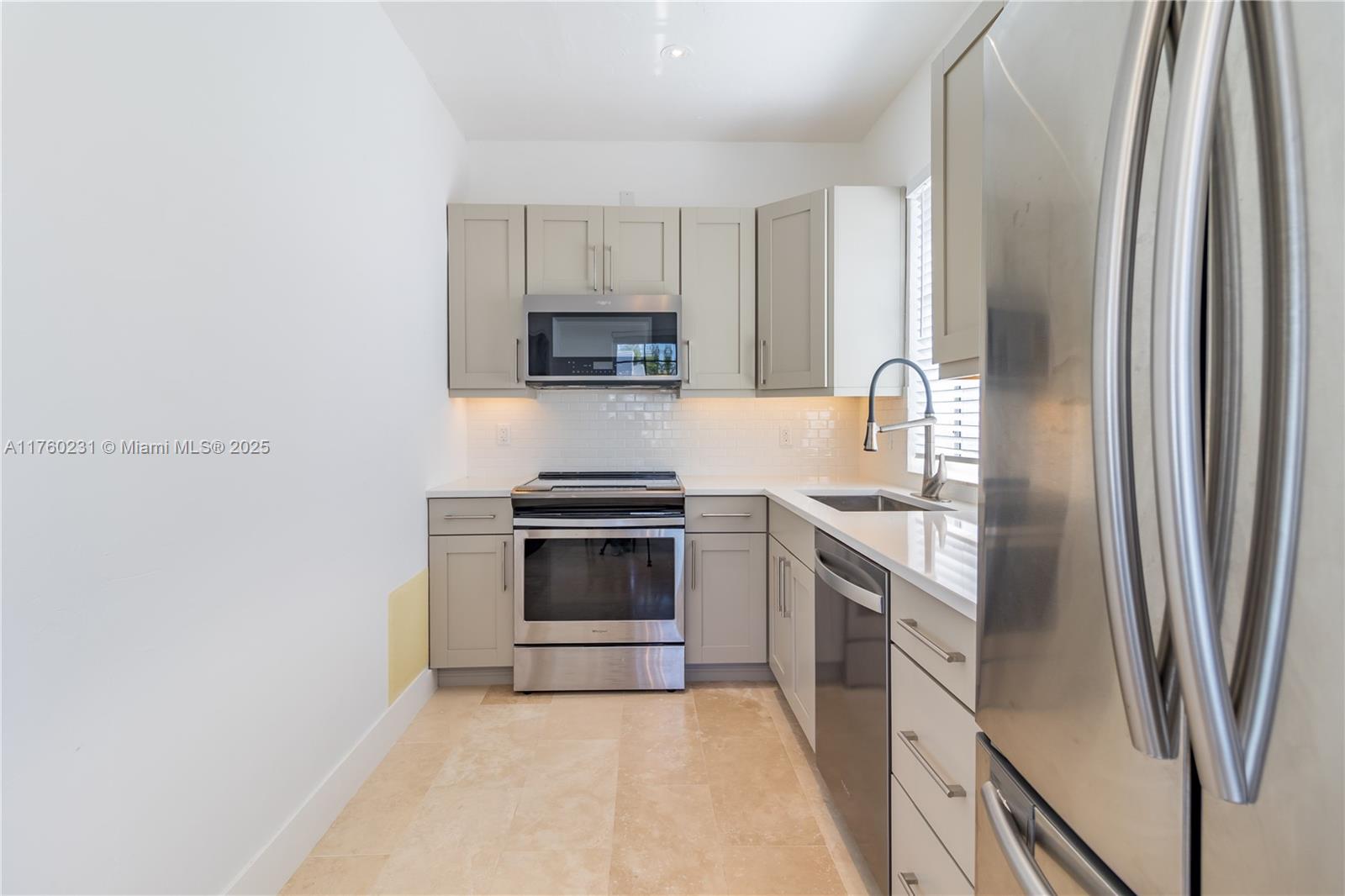 1569 Euclid Avenue, Unit 3 Miami Beach, FL 33139 - Photo 16 of 20 a kitchen with stainless steel appliances a refrigerator sink and microwave