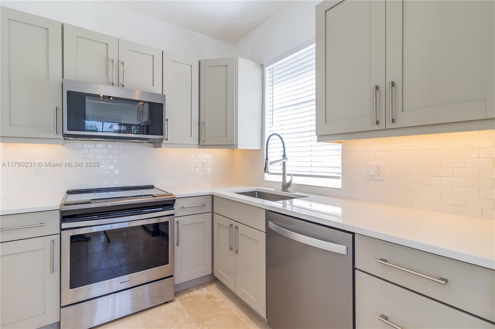 1569 Euclid Avenue, Unit 3 Miami Beach, FL 33139 - Photo 3 of 20 a kitchen with cabinets appliances a sink and a window