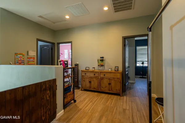 a kitchen view with wooden floor and electronic appliances