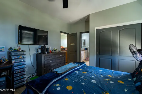 a bedroom with a bed and flat screen tv