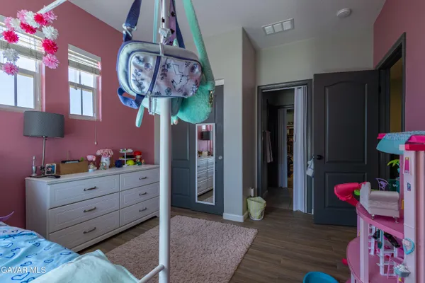a room that has a dresser and a chair in it