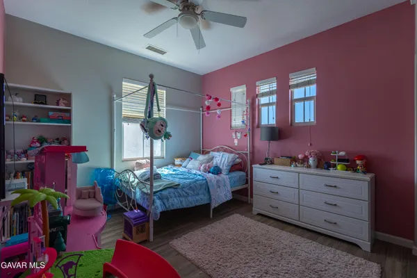 a bedroom with bed and a chandelier