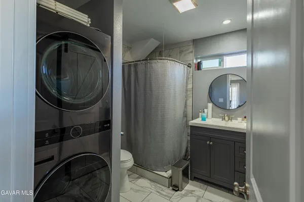 a utility room with sink dryer and washer