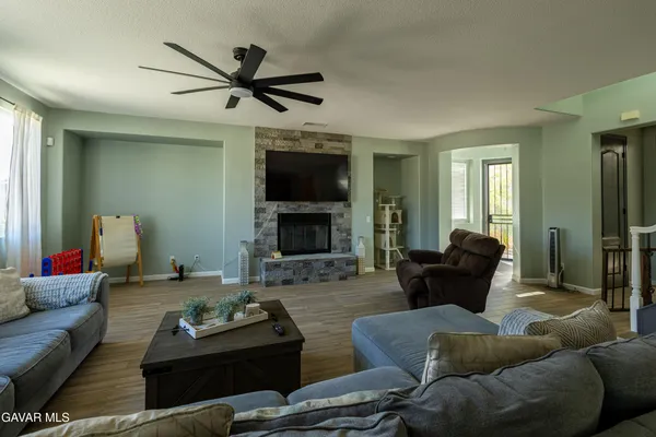 a living room with furniture and a fireplace