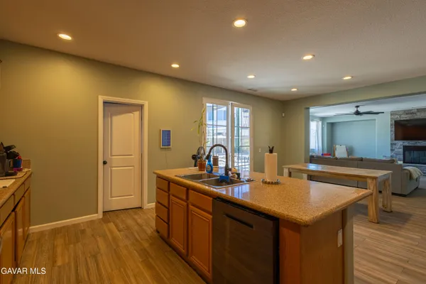 a kitchen with sink and mirror