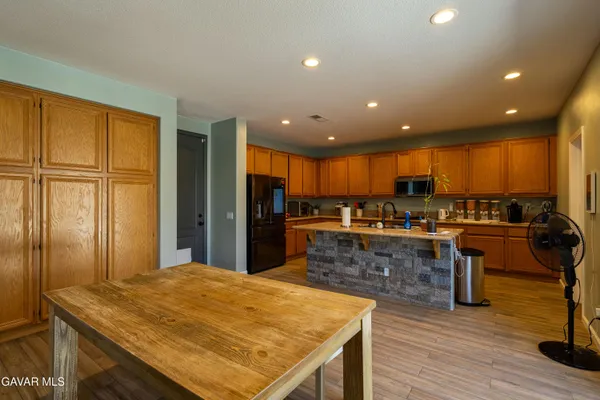 a kitchen with stainless steel appliances granite countertop a refrigerator and a sink