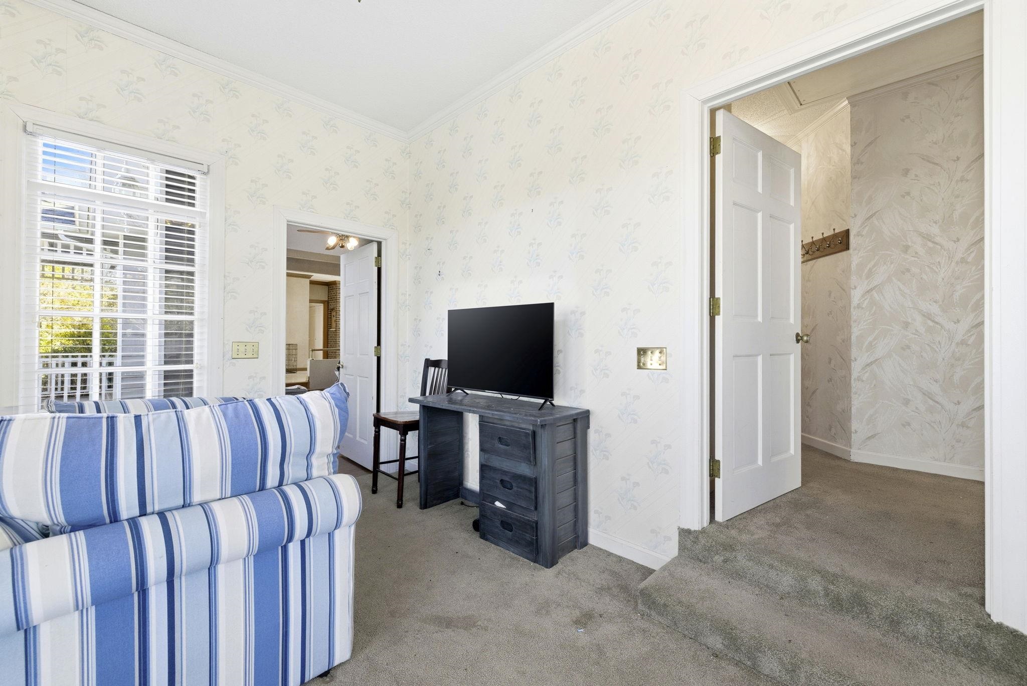 485 Carolina Drive Loris, SC 29569 - Photo 19 of 40 Carpeted living area with wallpapered walls and crown molding