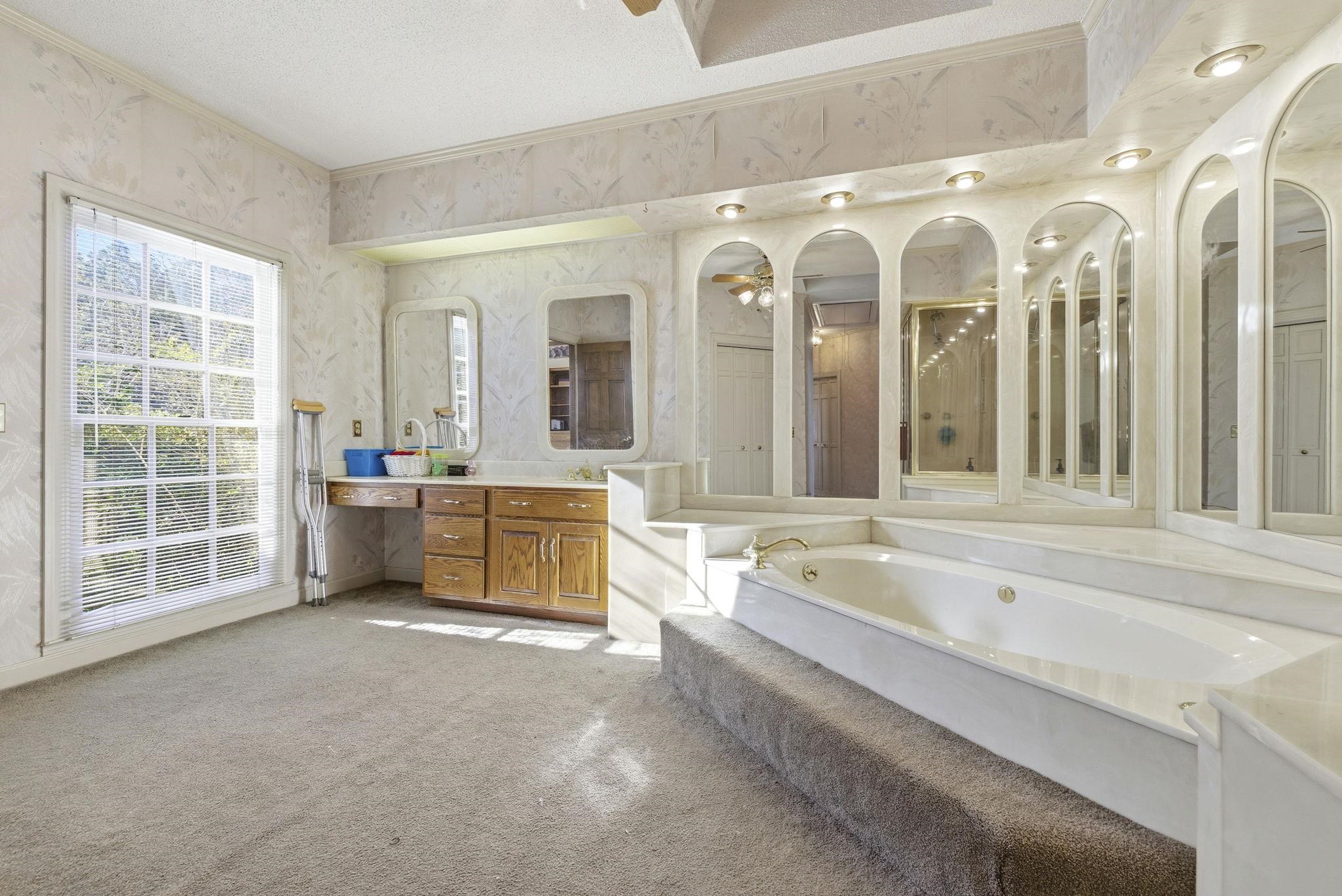 485 Carolina Drive Loris, SC 29569 - Photo 20 of 40 Bathroom featuring a garden tub, vanity, wallpapered walls, light carpet, and a textured ceiling