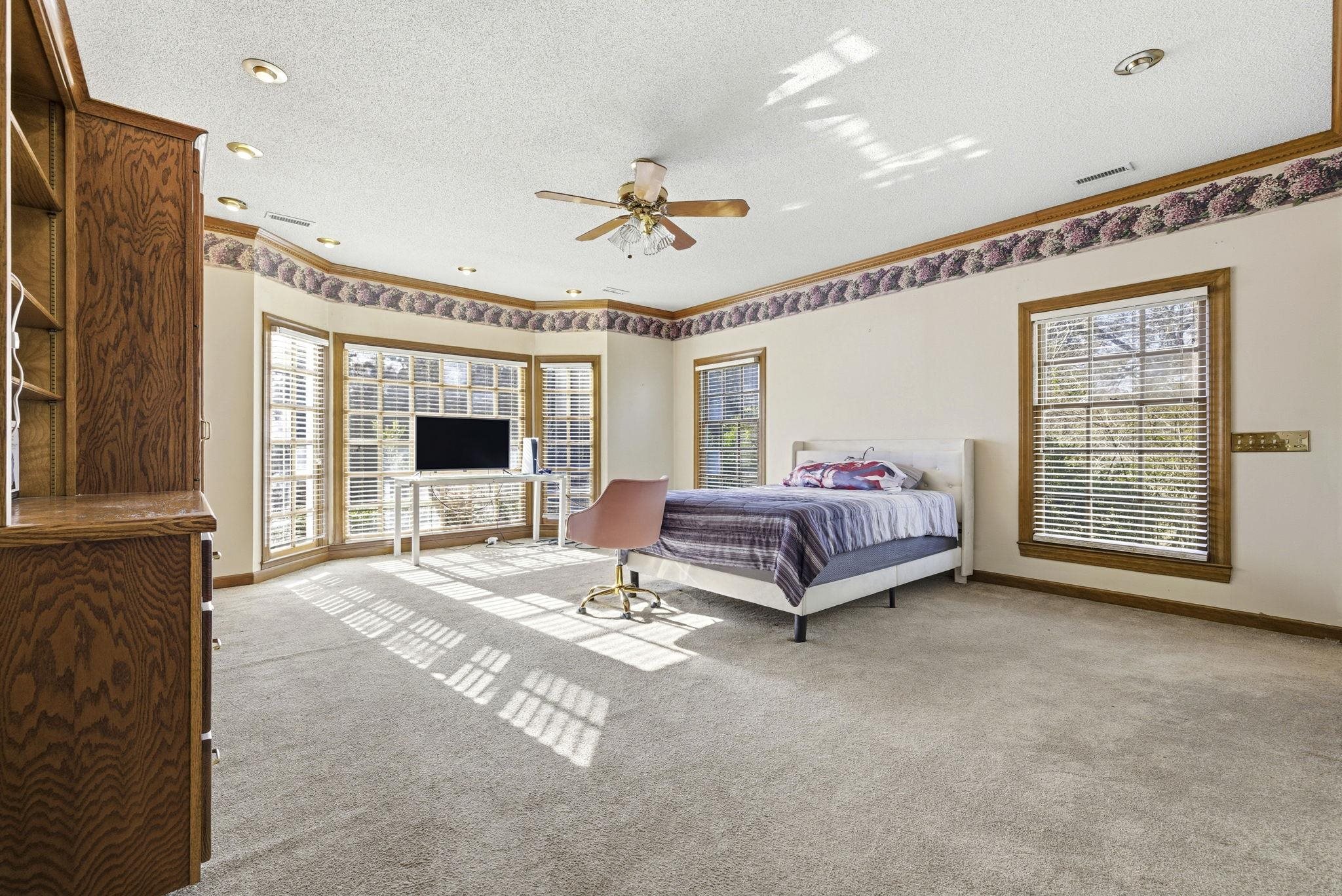 485 Carolina Drive Loris, SC 29569 - Photo 23 of 40 Bedroom with a ceiling fan, carpet floors, a textured ceiling, and ornamental molding