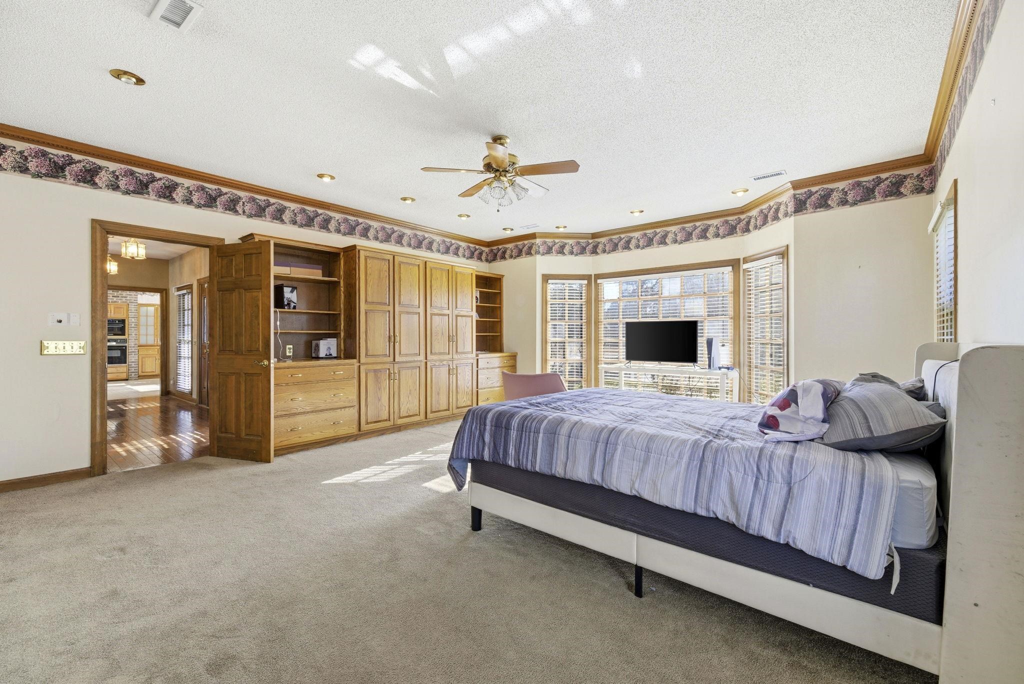 485 Carolina Drive Loris, SC 29569 - Photo 24 of 40 Bedroom featuring a textured ceiling, light carpet, a ceiling fan, and crown molding