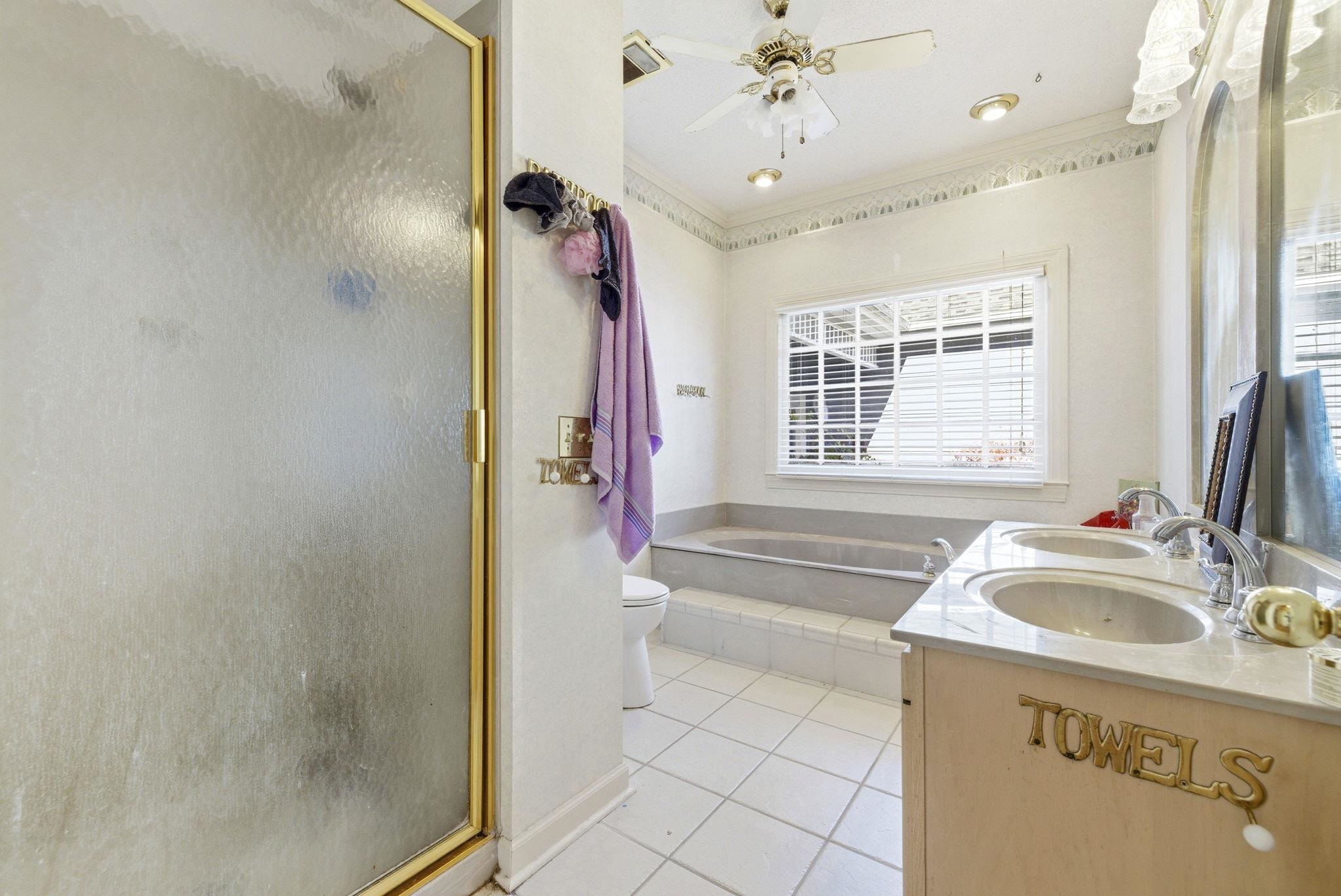 485 Carolina Drive Loris, SC 29569 - Photo 27 of 40 Full bathroom with a stall shower, ornamental molding, a garden tub, double vanity, and light tile patterned floors