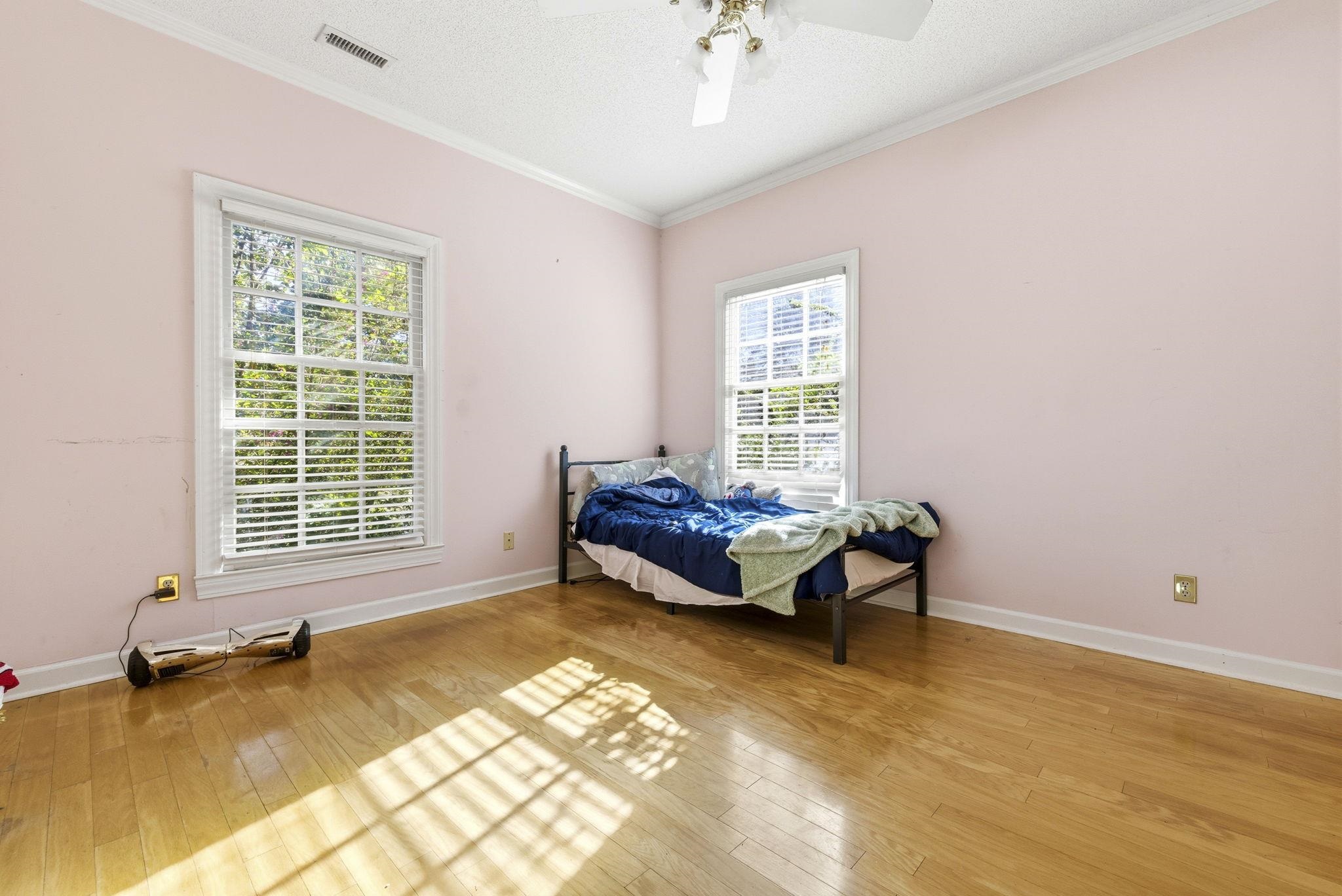 485 Carolina Drive Loris, SC 29569 - Photo 29 of 40 Bedroom featuring ornamental molding, a ceiling fan, a textured ceiling, and light wood finished floors