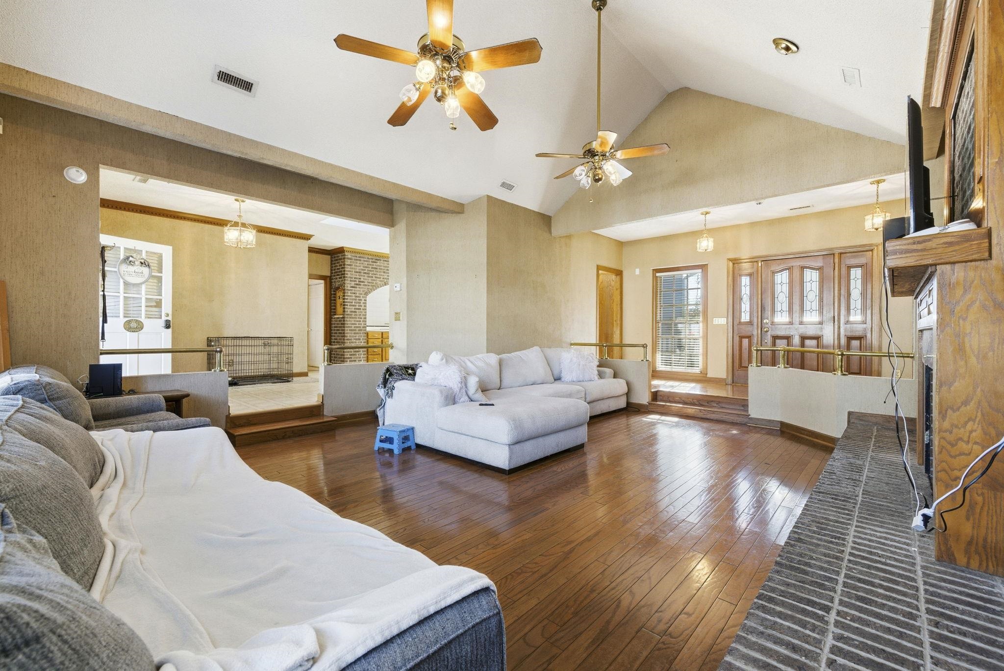 485 Carolina Drive Loris, SC 29569 - Photo 8 of 40 Living area with high vaulted ceiling, a fireplace with raised hearth, dark wood-style flooring, ceiling fan, and a chandelier