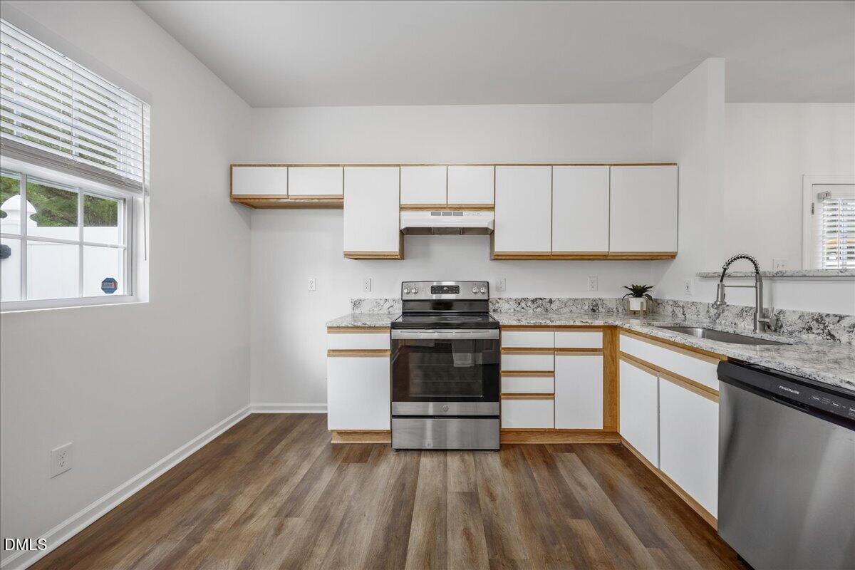 3831 Pin Oak Road Raleigh, NC 27604 - Photo 8 of 24 a kitchen with granite countertop a stove and a sink