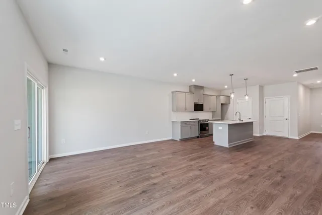 a view of kitchen with kitchen island refrigerator stove microwave and cabinets