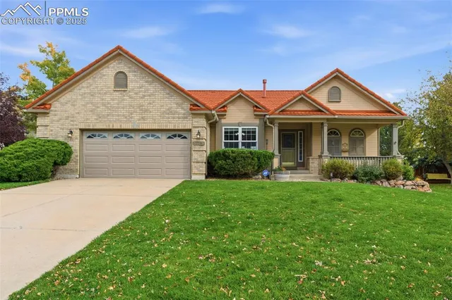 a front view of a house with yard and green space