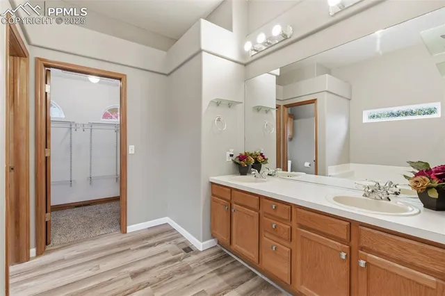 a spacious bathroom with a double vanity sink mirror and next to a window