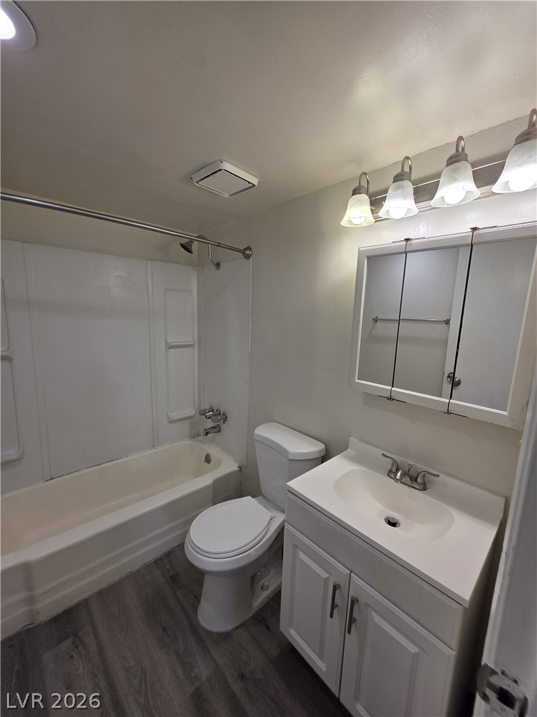 1075 East Desert Inn Road, Unit 5 Las Vegas, NV 89109 - Photo 8 of 12 Functional full bathroom featuring a tub-shower combination, modern vanity, and plank flooring.